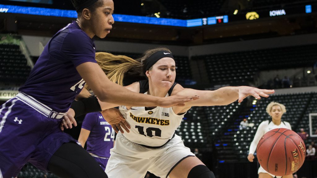 Iowa forward Megan Gustafson and Northwestern forward Pallas Kunaiya-Akpanah attempt to take control of the ball during the Iowa/Northwestern Big Ten tournament basketball game at Bankers Life Fieldhouse in Indianapolis on Thursday, March, 1, 2018. The Hawkeyes defeated the Wildcats, 55-45. Iowa takes on No.4 Minnesota on Friday. (Lily Smith/The Daily Iowan)