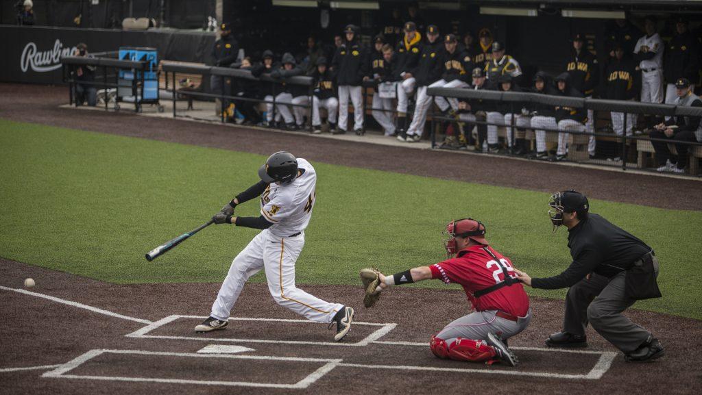 Iowa outfielder Robert Neustrom makes contact during Iowa’s doubleheader against number 11 ranked Indiana at Duane Banks Field on Friday March 23, 2018. The Hoosiers won the first game 4-2 and the Hawkeyes won the second game 5-1. (Nick Rohlman/The Daily Iowan)