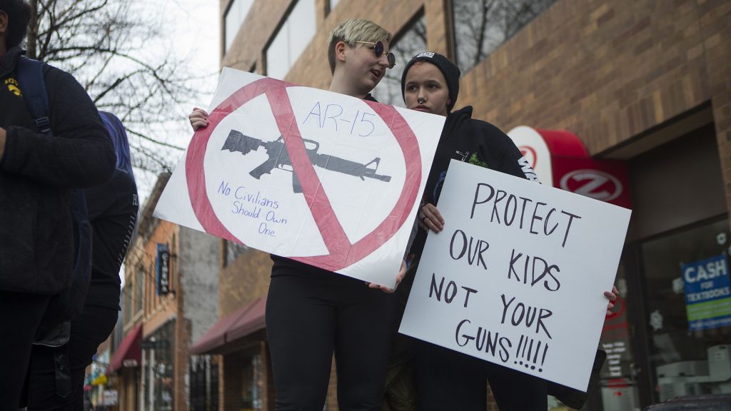 Southeast Junior High School 8th grader Casper Ferreria and Iowa City High School junior Illeana Knaap protest on the Ped Mall on Monday, Feb. 19, 2018. The protest was sparked after news of another school shooting, at Marjory Stoneman Douglas High School, in Parkland, FL on, Feb. 14. (Lily Smith/The Daily Iowan)
