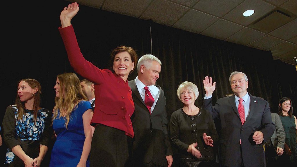 Lt. Gov. Kim Reynolds and Gov. Terry Branstad along with their spouses wave to the crowd at the West Des Moines Marriott on Tuesday, Nov. 4, 2014. (The Daily Iowan/Anna Kilzer)