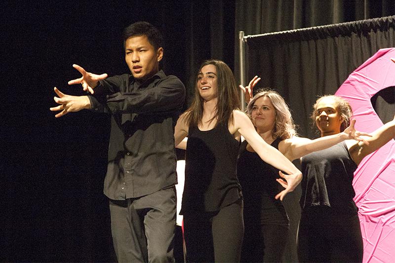 Contestant Rogie Soeu performs with members of the UI Dance Club for his talent during the first Mr. Pink competition held in the IMU Second Floor Ballroom on Mar. 4, 2018. Alpha Kappa Delta Phi hosted the first ever Mr. Pink contest, during which male students helped raise awareness for breast cancer by competing in a beauty competition. (Katie Goodale/ The Daily Iowan)