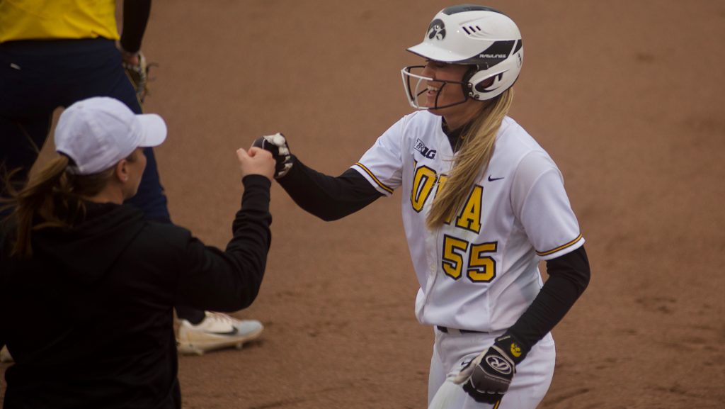 McKenzie Schneider high-fives Assistant Coach Rachel West during Womens Softball Iowa vs. University of Michigan at Bob Pearl Field on March 23, 2018. The Hawkeyes defeated the Wolverines 4-3. (Olivia Sun/The Daily Iowan)