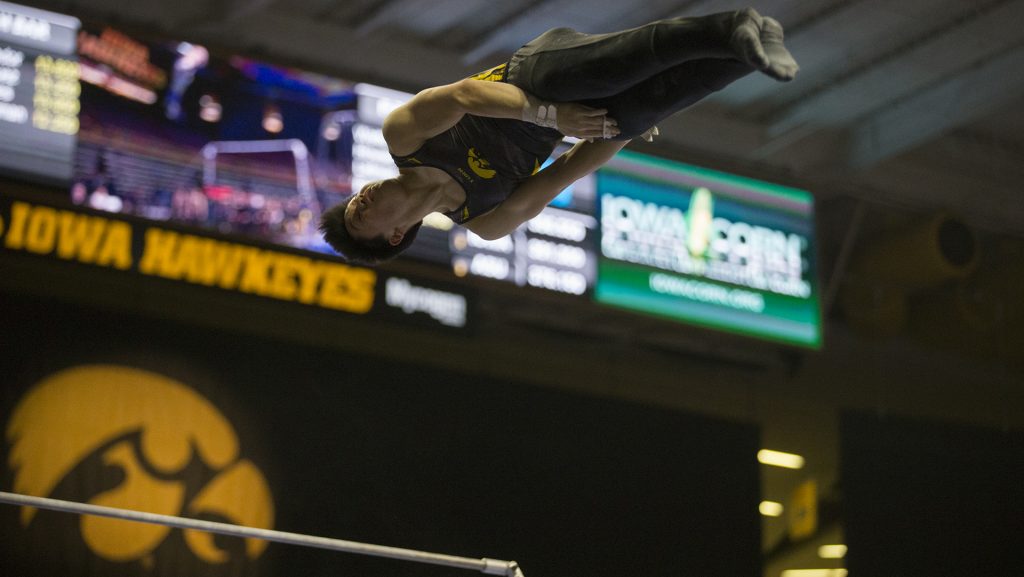 Bennet Huang performs on the horizontal bar during mens gymnastics Iowa vs. Penn State and Arizona State on Mar. 3, 2018 at Carver Hawkeye Arena. Huang earned a 12.750 for his performance. The Hawkeyes defeated the Lions and the Sun Devils 404.050 to 396.550 and 376.150. (Katie Goodale/The Daily Iowan)