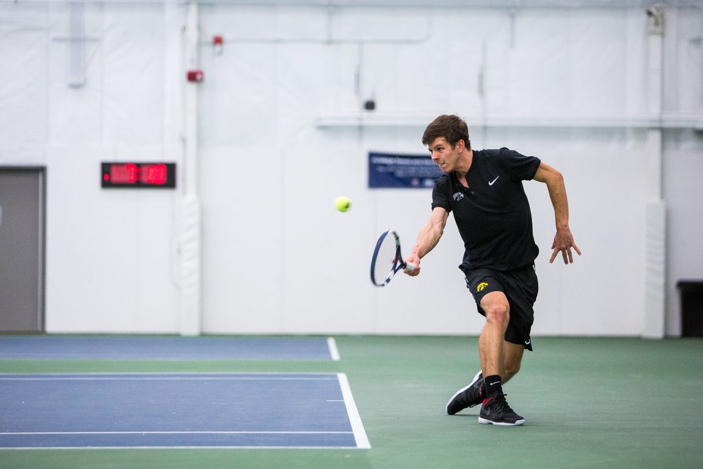 Iowa tennis player Piotr Smietana volleys the ball during a match against Cornell University on Friday, Mar. 2, 2018. Smietana lost his match 7-6 (7-4), 2-6, 6-4 and the Big Red defeated the Hawkeyes 4-3. (David Harmantas/The Daily Iowan)