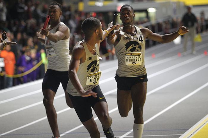 Antonio Woodward and Raymonte Dow make an exchange in the 4x400 meter relay during the Larry Wieczorek Invitational meet in Iowa City, Iowa; Saturday January 20, 2018. Their relay team finished second in the heat. (Paxton Corey/The Daily Iowan)