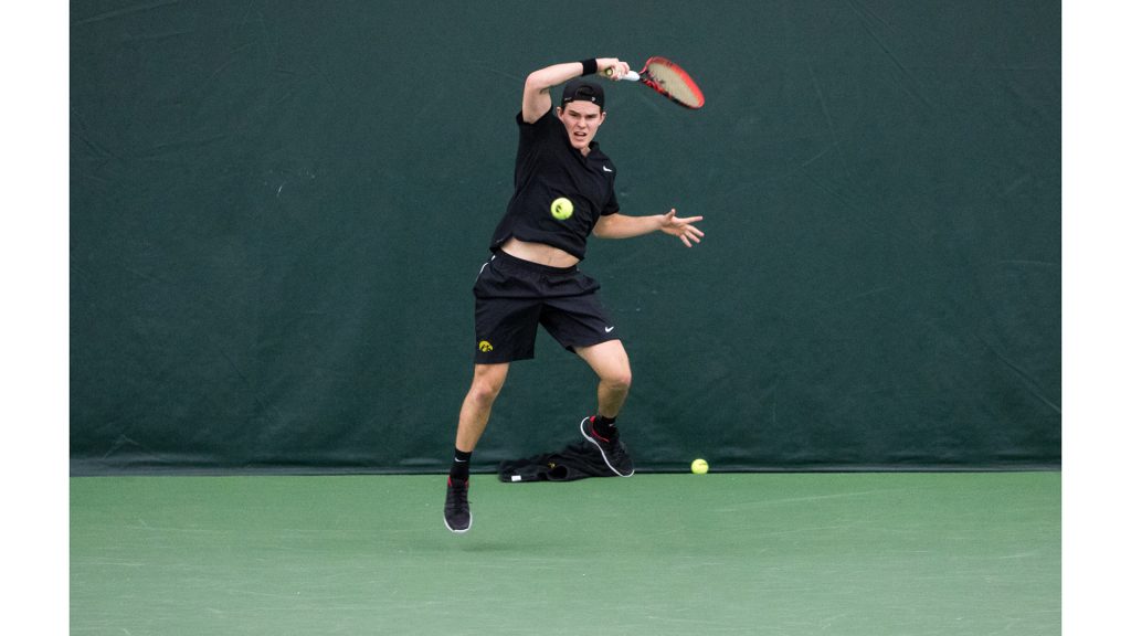 Iowa tennis player Jonas Larson  volleys the ball during a match against Cornell University on Friday, Mar. 2, 2018. Larson won his match 6-2, 6-0 and the Big Red defeated the Hawkeyes 4-3. (David Harmantas/The Daily Iowan)