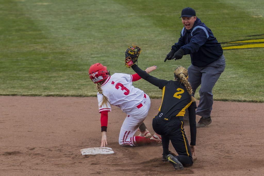 A second base umpire calls a play during the Iowa/Wisconsin softball game at Bob Pearl Field  on Sunday, April 8, 2018. The Hawkeyes defeated the Badgers in the third game of the series, 5-3. (Lily Smith/The Daily Iowan)