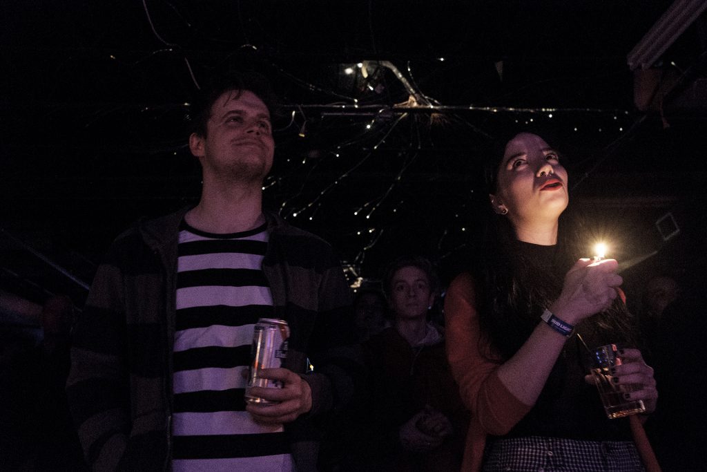 A fan holds a lighter as Hot Tang performs at Gabe’s in Iowa City on Wednesday, April 4, 2018. The show was one of a variety of events during the second day of the Mission Creek festival. (Nick Rohlman/The Daily Iowan)