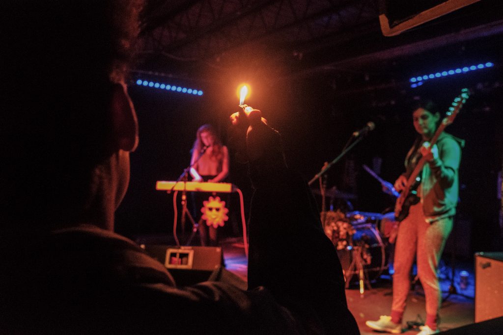 A fan waves a lighter as Hot Tang performs at Gabe’s in Iowa City on Wednesday, April 4, 2018. The show was one of a variety of events during the second day of the Mission Creek festival. (Nick Rohlman/The Daily Iowan)