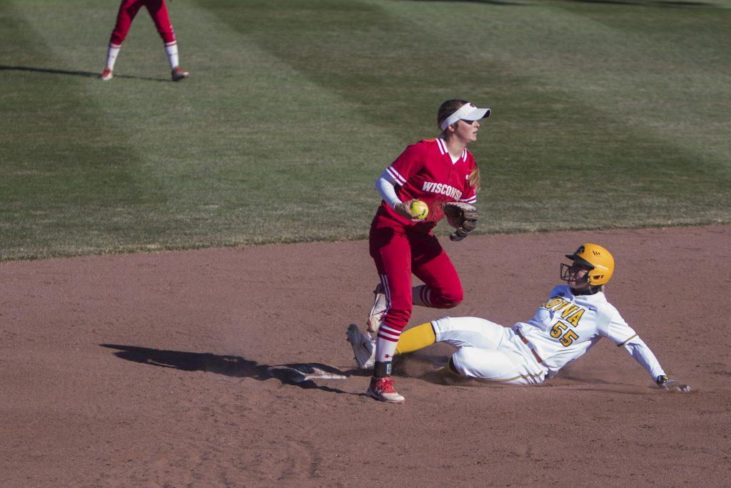 Iowa shortstop McKenzie Schneider slides into second base during the Iowa/Wisconsin softball game at Bob Pearl Field  on Saturday, April 7, 2018. The Hawkeyes defeated the Badgers in the second game of the series, 4-3. (Lily Smith/The Daily Iowan)