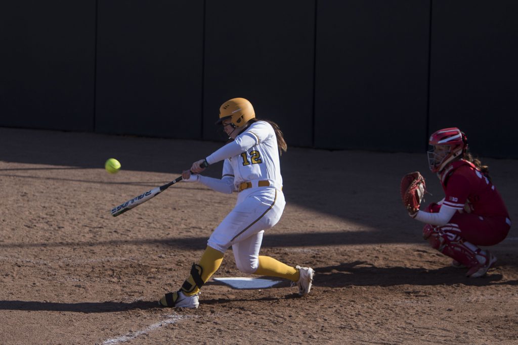 Iowa catcher Angela Schmiederer bats during the Iowa/Wisconsin softball game at Bob Pearl Field  on Saturday, April 7, 2018. The Hawkeyes defeated the Badgers in the second game of the series, 4-3. (Lily Smith/The Daily Iowan)