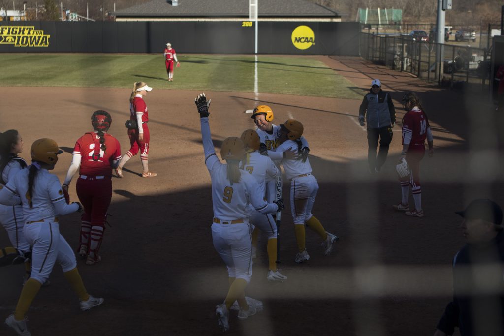 Iowa players celebrate a win during the Iowa/Wisconsin softball game at Bob Pearl Field  on Saturday, April 7, 2018. The Hawkeyes defeated the Badgers in the second game of the series, 4-3. (Lily Smith/The Daily Iowan)