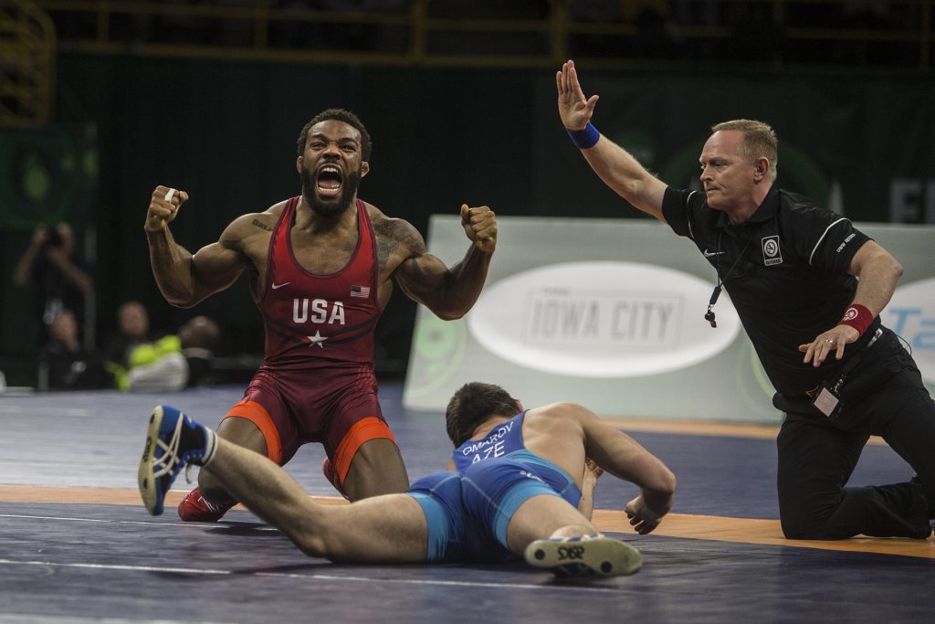 Americas Jordan Burroughs (red) celebrates his victory over Gasjimurad Omarov (blue) of Azerbaijan at 74 kg during the final round of the 2018 Mens Freestyle World Cup at Carver-Hawkeye Arena on Saturday, April 7. Team USA placed first, defeating Azerbaijan 6-4 in the finals. (Ben Allan Smith/The Daily Iowan)