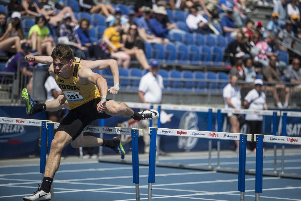 Iowa's Chris Douglas, right, competes for first in the men's 110 meter hurdles during the 2018 Drake Relays at Drake Stadium in Des Moines, Iowa on Friday, April 27, 2018. Douglas finished first with a time of 14.03. (Ben Allan Smith/The Daily Iowan)