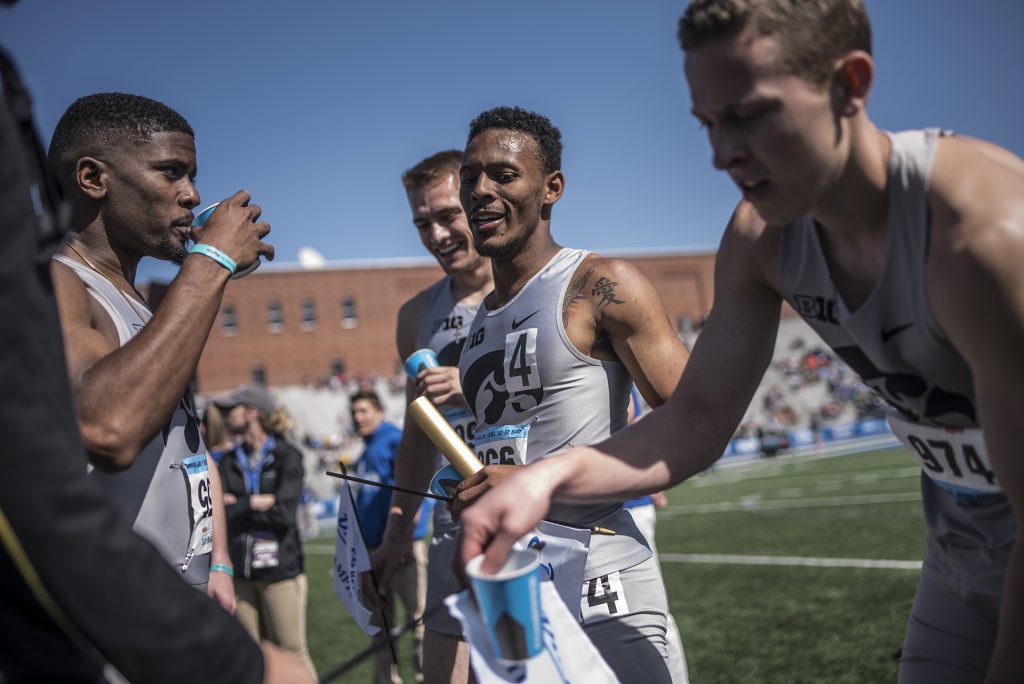 From left: Iowas DeJuan Frye, Collin Hofacker, MarYea Harris, and Chris Thompson rehydrate following their victory in the mens 4x400 meter relay during the 2018 Drake Relays at Drake Stadium in Des Moines, Iowa on Saturday, April 28, 2018. 
