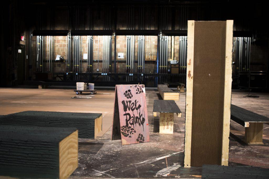 A 'Wet Paint' sign is seen on stage inside the E.C. Mabie Theatre in the Theatre Building on Thursday, March 29, 2018. (Lily Smith/The Daily Iowan)