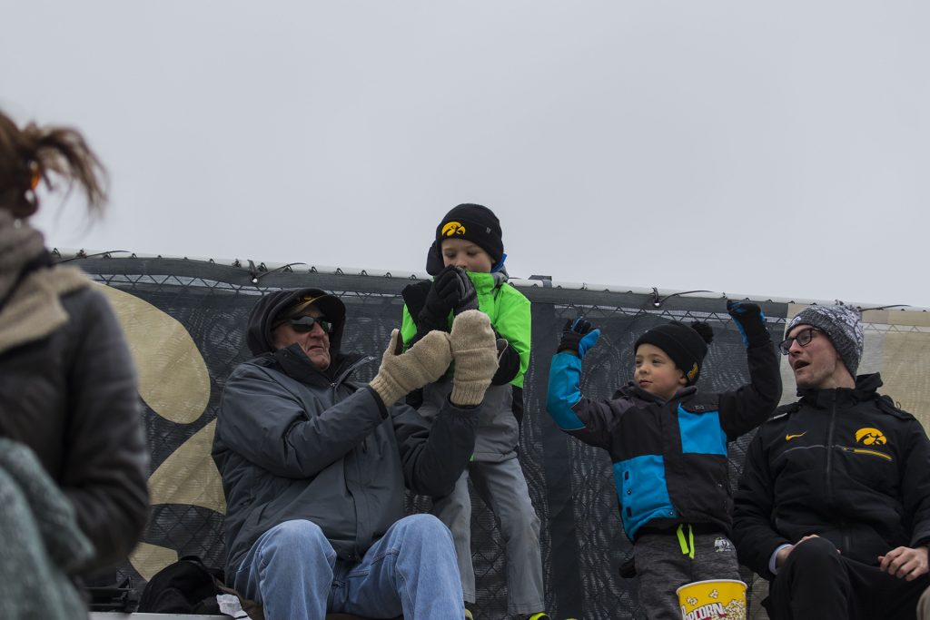 A fan catches a t shirt during the Iowa/Wisconsin softball game at Bob Pearl Field  on Sunday, April 8, 2018. The Hawkeyes defeated the Badgers in the third game of the series, 5-3. (Lily Smith/The Daily Iowan)