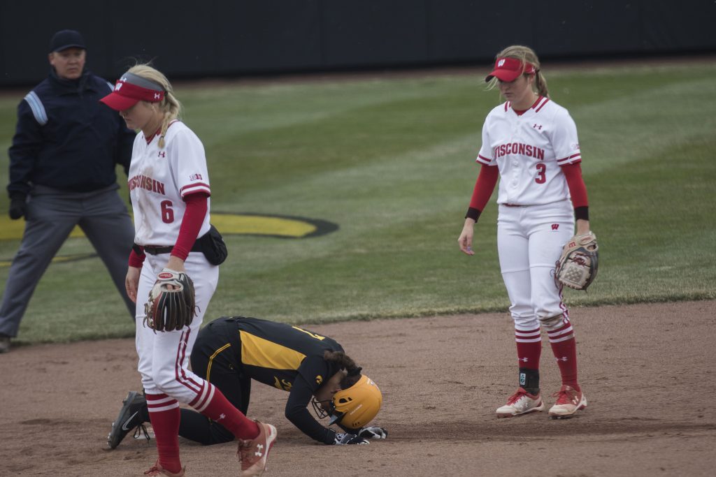 Iowa's Lea Thompson kneels next to the base during the Iowa/Wisconsin softball game at Bob Pearl Field  on Sunday, April 8, 2018. The Hawkeyes defeated the Badgers in the third game of the series, 5-3. (Lily Smith/The Daily Iowan)