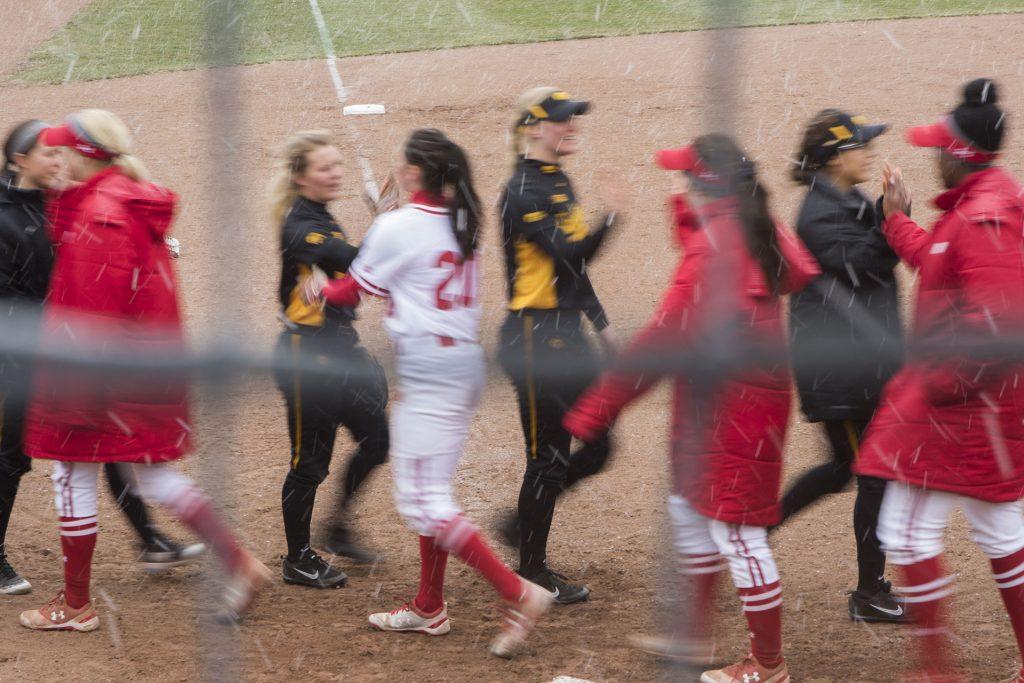 Wisconsin and Iowa players high five after the Iowa/Wisconsin softball game at Bob Pearl Field  on Sunday, April 8, 2018. The Hawkeyes defeated the Badgers in the third game of the series, 5-3. (Lily Smith/The Daily Iowan)