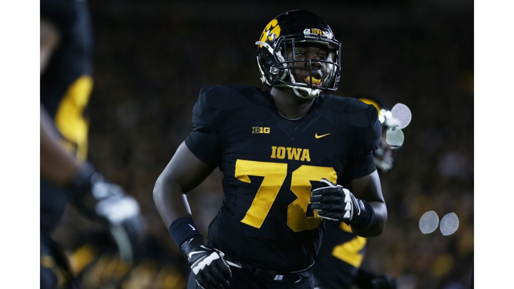Iowa offensive lineman James Daniels runs to the sidelines in Kinnick Stadium on Saturday, Nov. 14, 2015. The Hawkeyes defeated the Golden Gophers, 40-35 to stay perfect on the season.