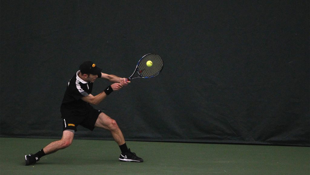 Iowa's Jake Jacoby returns the ball during a match at the Hawkeye Tennis and Recreation Center on Friday, Mar. 11, 2016. Overall, Iowa lost to Nebraska 3-4. (The Daily Iowan/Ting Xuan Tan)