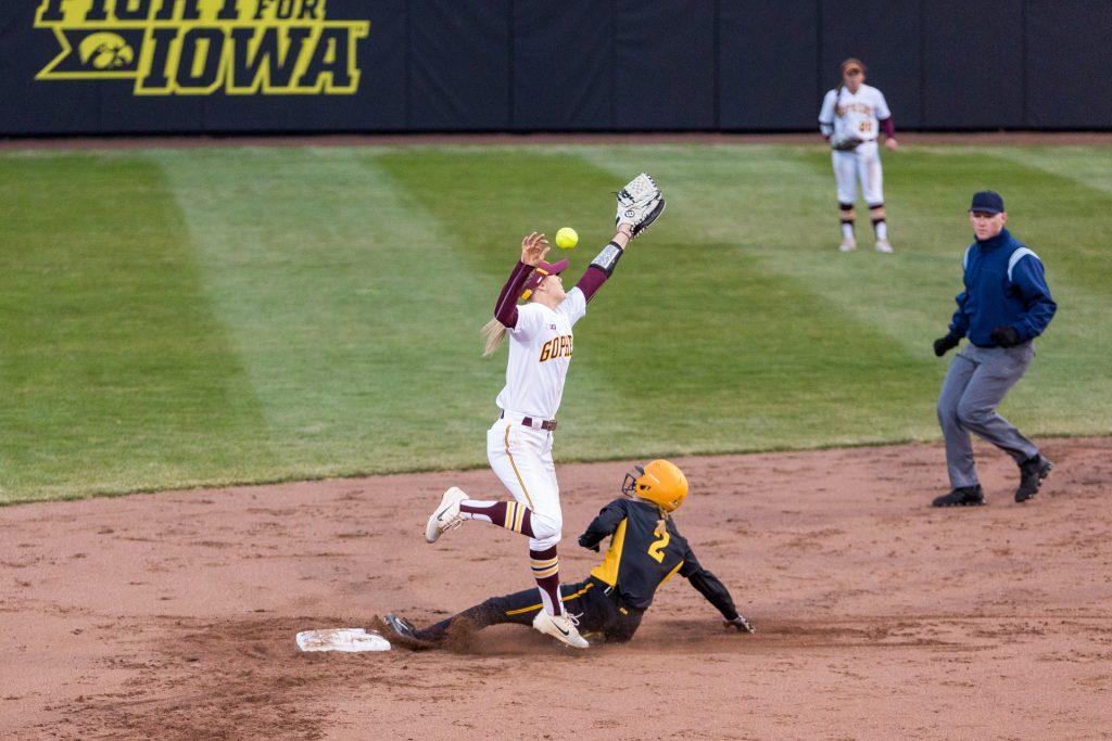 University+of+Iowa+softball+player+Aralee+Bogar+slides+into+second+as+the+ball+gets+past+the+defender+during+the+second+game+of+a+double+header+against+the+University+of+Minnesota+on+Friday%2C+Apr.+13%2C+2018.+The+Gophers+defeated+the+Hawkeyes+11-1.+%28David+Harmantas%2FThe+Daily+Iowan%29