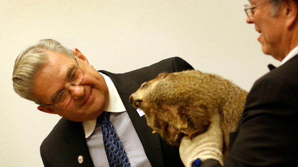 KRT US NEWS STORY SLUGGED: GROUNDHOG KRT PHOTOGRAPH BY KEN CEDENO/KRT (December 7) WASHINGTON, DC--  Rep. John Peterson (R-PA) leans over to check out Punxsutawney Phil while Bill Cooper holds him December 7, 2004 during a press conference on Capitol Hill in Washington, D.C. Peterson is defending a $100,000 grant which he secured for the Discovery Center in the 2005 Omnibus Appropriations bill against charges made by Taxpayers for Common Sense that the grant was a pork project. (lde) 2004