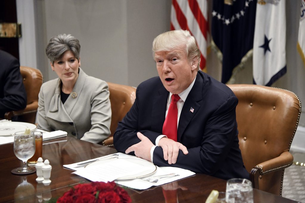 U.S President Donald Trump speaks as Sen. Joni Ernst from Iowa looks on during a meeting with Republican senators on Tuesday, Dec. 5, 2017 in the Roosevelt Room of the White House   in Washington, D.C. (Olivier Douliery/Abaca Press/TNS)