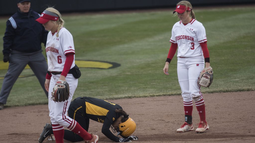 Iowas Lea Thompson kneels next to the base during the Iowa/Wisconsin softball game at Bob Pearl Field  on Sunday, April 8, 2018. The Hawkeyes defeated the Badgers in the third game of the series, 5-3. (Lily Smith/The Daily Iowan)
