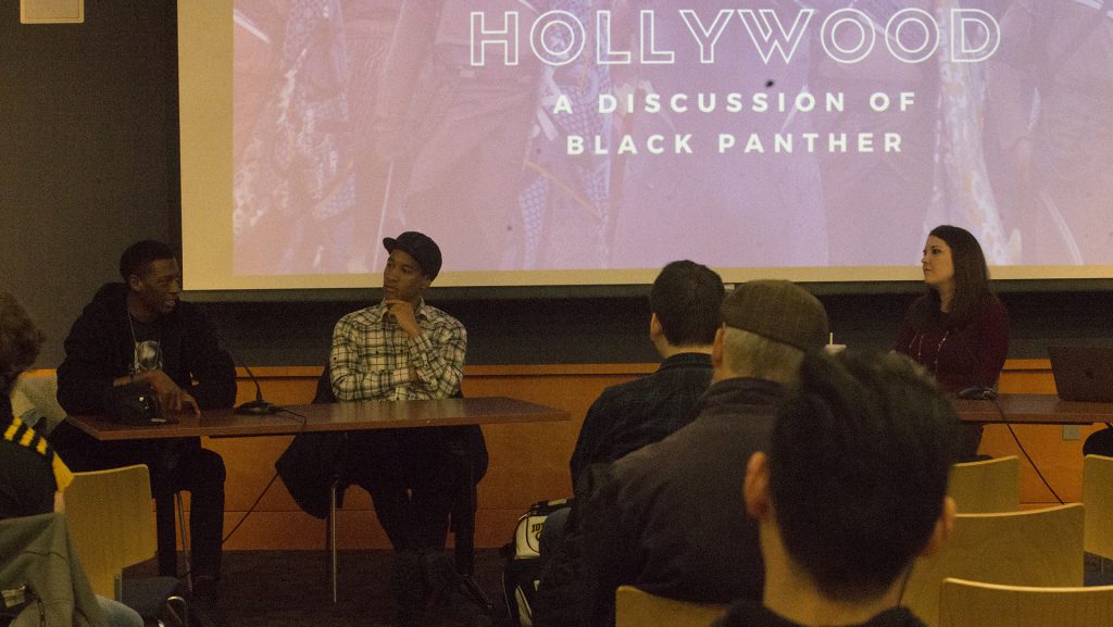 Panelists+address+the+impact+of+Black+Panther+within+the+African-American+community+during+the+Wakanda+to+Hollywood+panel+at+the+Iowa+City+Public+Library+on+April+15%2C+2018.+The+panel+discussed+the+importance+of+the+Black+Panther+film+and+how+it+related+to+other+superhero+movies.+%28Ashol+Aguek%2FThe+Daily+Iowan%29