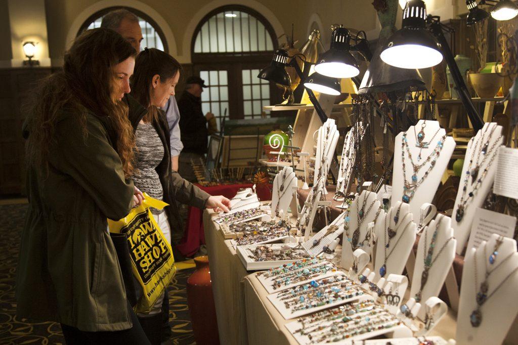 A family looks at jewelry during the Spring Art Expose in the IMU Main Lounge on Saturday Apr. 21, 2018. Put on by the UI Fine Arts Council, the Spring Art Expose celebrates local artists. (Katie Goodale/The Daily Iowan)