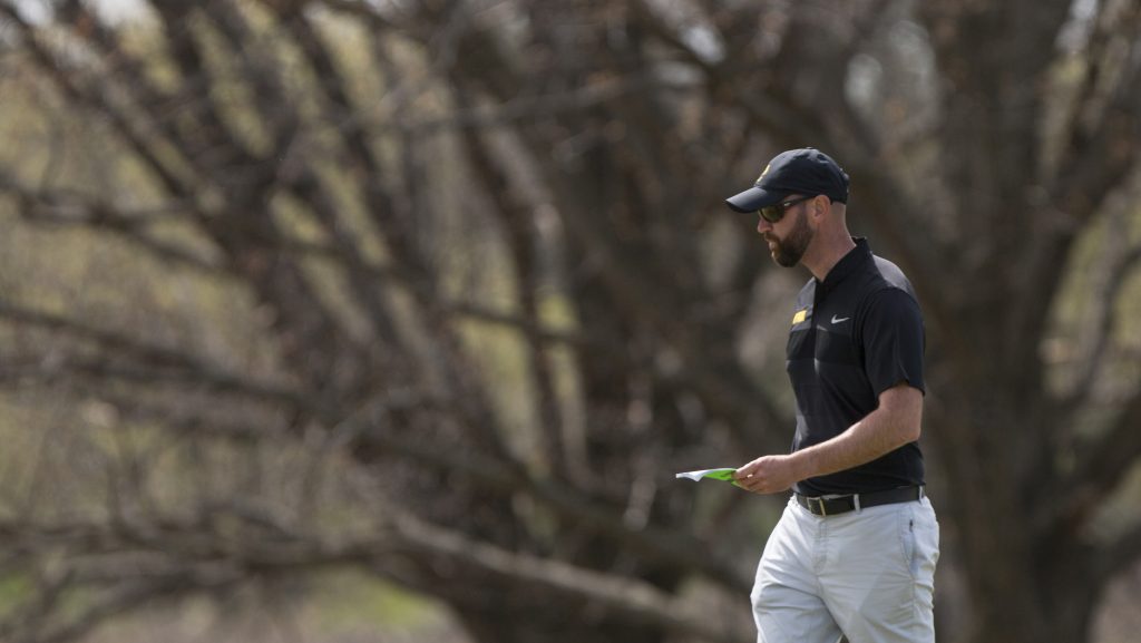 Iowa head coach Tyler Stith walks on the green during the Hawkeye Invitational at Finkbine Golf Course on Sunday, April 16, 2017. The Hawkeyes finished second, behind Texas Tech, in the tournament after three rounds scoring 859 (-5; 289, 285, 285). 