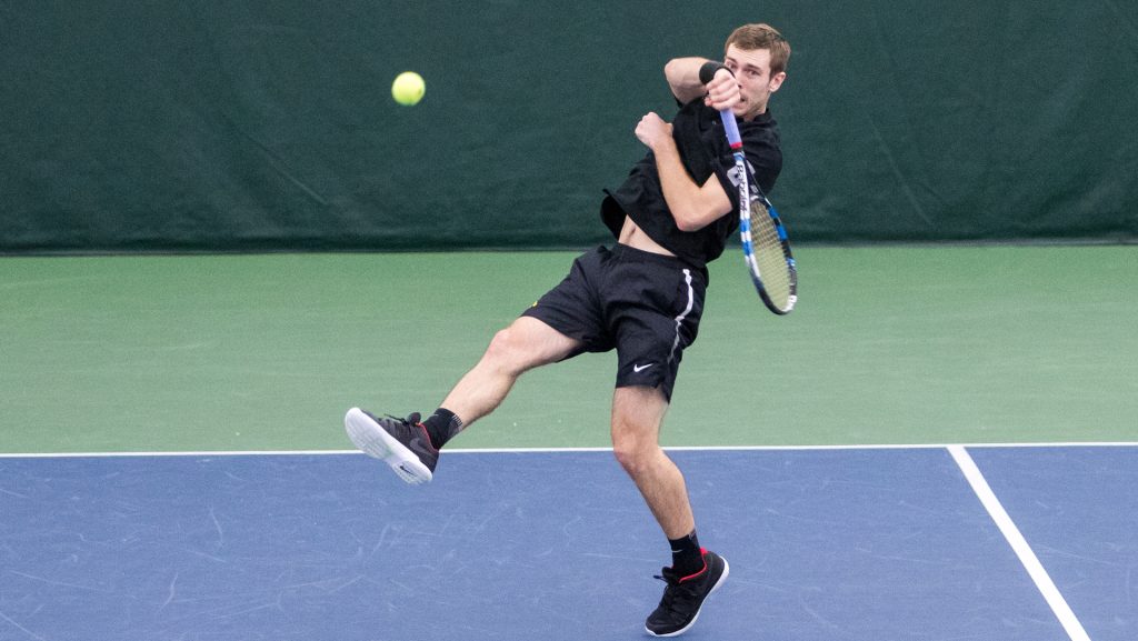 Iowa tennis player Jake Jacoby volleys the ball during a doubles match against Cornell University on Friday, Mar. 2, 2017. Jacoby lost his match 5-7 and the Big Red defeated the Hawkeyes 4-3. (David Harmantas/The Daily Iowan)