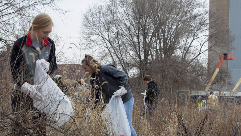 From left: Freshman Emma Rotz and Freshman Abby Thornton pick up trash by the Iowa River during IIHRs river clean up on Saturday Apr. 21, 2018. THe IIHR hosted an Earth Day event during which community members were invited to come pick up trash along the Iowa River. (Katie Goodale/The Daily Iowan)