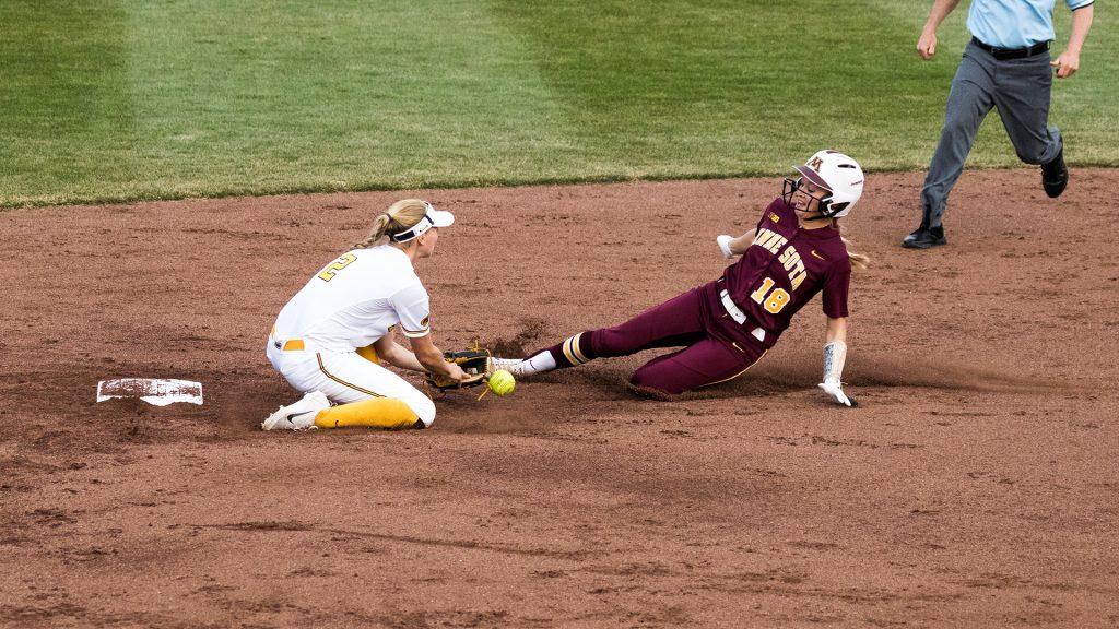 University of Iowa softball player Aralee Bogar drops the ball during a game against the University of Minnesota on Thursday, Apr. 12, 2018. The runner was safe at second base and the Gophers defeated the Hawkeyes 8-0. (David Harmantas/The Daily Iowan)