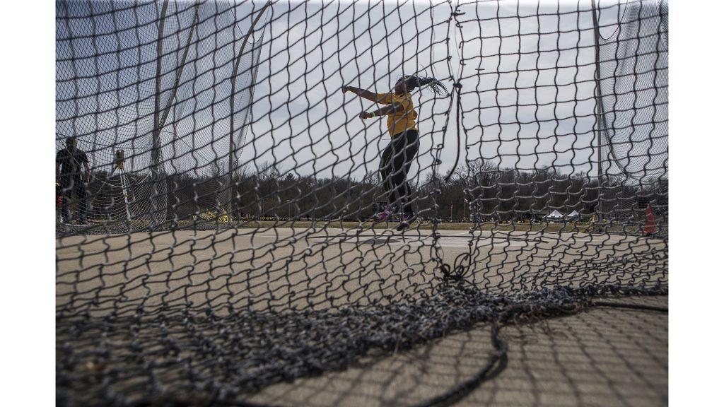 Iowa sophomore Laulauga Tausaga attempts a discus throw during the 19th annual Musco Twilight meet at the Francis X. Cretzmeyer Track in Iowa City on Thursday, April 12. Tausaga finished first in the event with a distance of 56.69 meters. (Ben Allan Smith/The Daily Iowan)