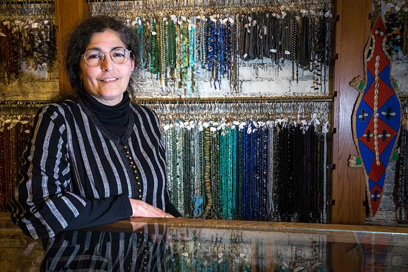 Karen Kubby, owner of Beadology, poses for a portrait behind the counter in her store in Iowa City on Saturday, March 31, 2018. (Matthew Finley/The Daily Iowan)