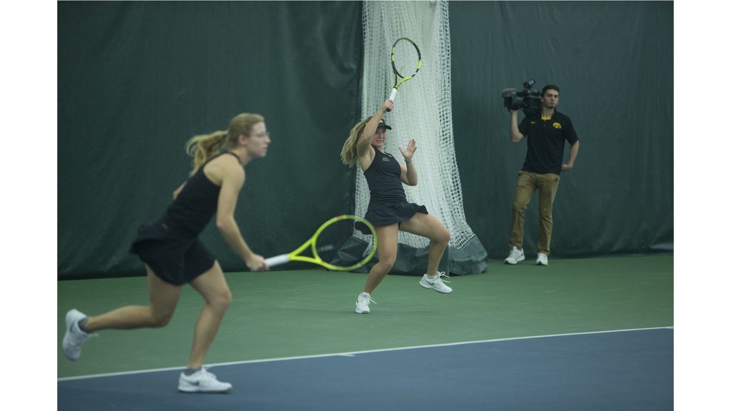 Iowas Danielle Burich wails a forehand during a tennis match between Iowa and Ohio State in Iowa City on Sunday, March 25, 2018. The Buckeyes swept the doubles point and won the match, 6-1. (Shivansh Ahuja/The Daily Iowan)