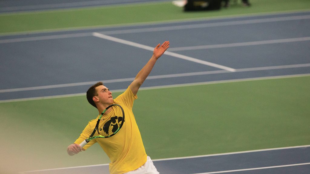 Iowas Piotr Smietana serves a ball during the Iowa/Creighton tennis match at the Hawkeye Tennis and Recreation Complex on Friday, Feb. 16, 2018. The Hawkeyes defeated the Bluejays, 7-0. 