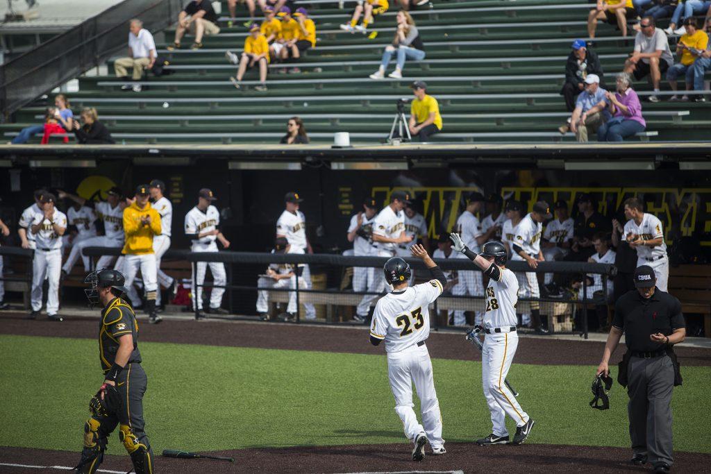 Iowa's Kyle Crowl high fives Chris Whelan during the Iowa/Mizzou baseball game at Duane Banks Field on Tuesday, May 1, 2018. The Tigers defeated the Hawkeyes, 17-16, with two extra innings. (Lily Smith/The Daily Iowan)