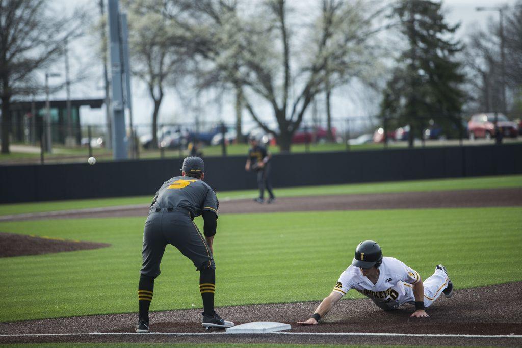 Iowa catcher Austin Guzzo attempts to touch first base before being tagged during the Iowa/Mizzou baseball game at Duane Banks Field on Tuesday, May 1, 2018. The Tigers defeated the Hawkeyes, 17-16, with two extra innings. (Lily Smith/The Daily Iowan)