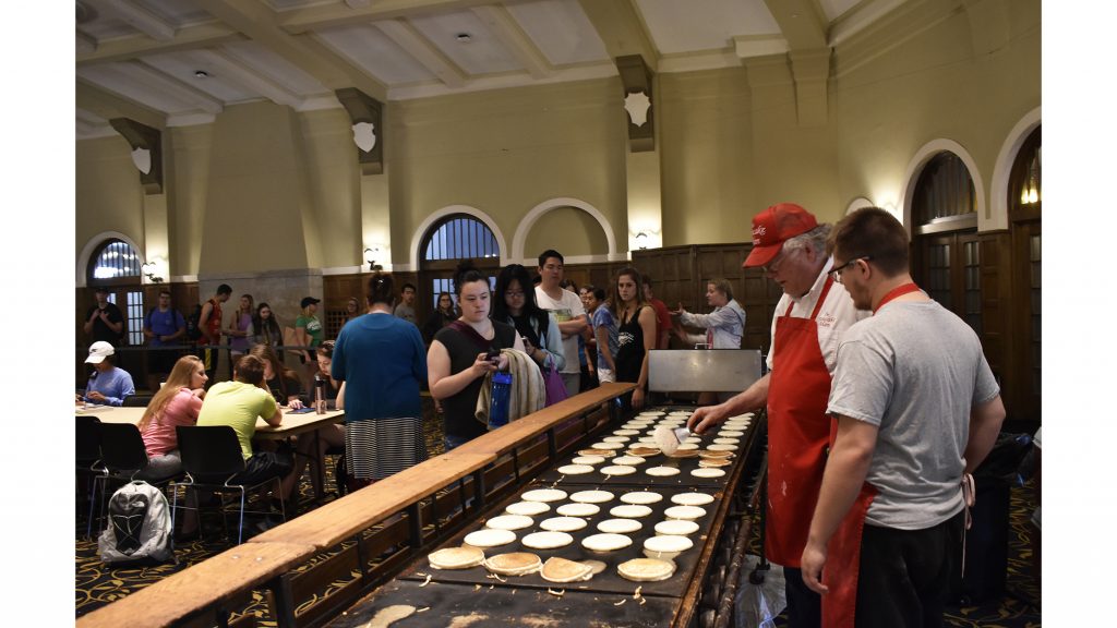 Students wait in line for breakfast at the Iowa Memorial on Monday, May 7, 2018. Flippin into Finals featured the Pancake Man who frequently tossed pancakes to students in the air. (Sid Peterson/The Daily Iowan)