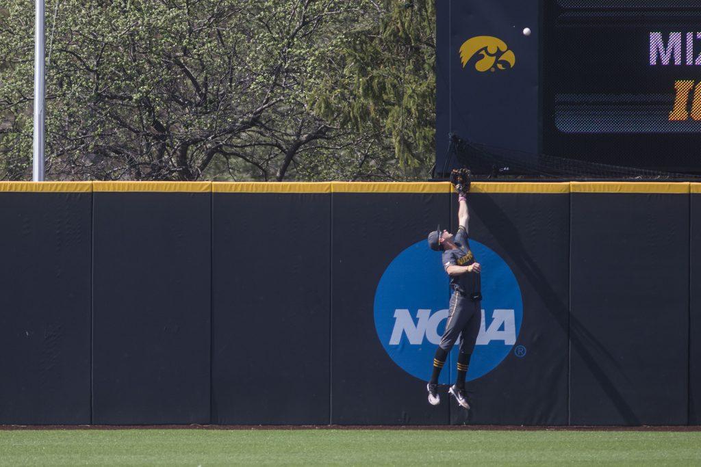 A Mizzou outfielder attempts to catch a home run during the Iowa/Mizzou baseball game at Duane Banks Field on Tuesday, May 1, 2018. The Tigers defeated the Hawkeyes, 17-16, with two extra innings. (Lily Smith/The Daily Iowan)