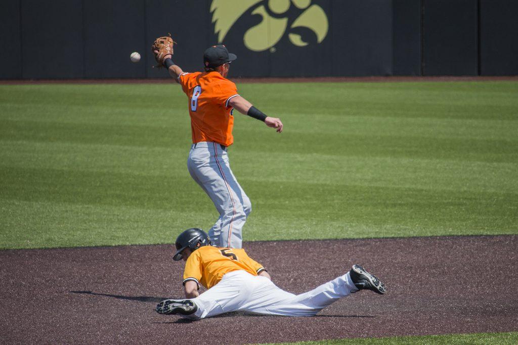 Iowa catcher Tyler Cropley dives back to second base during baseball Iowa vs. Oklahoma State at Duane Banks Field on May 6, 2018. The Hawkeyes defeated the Cowboys 11-3. 