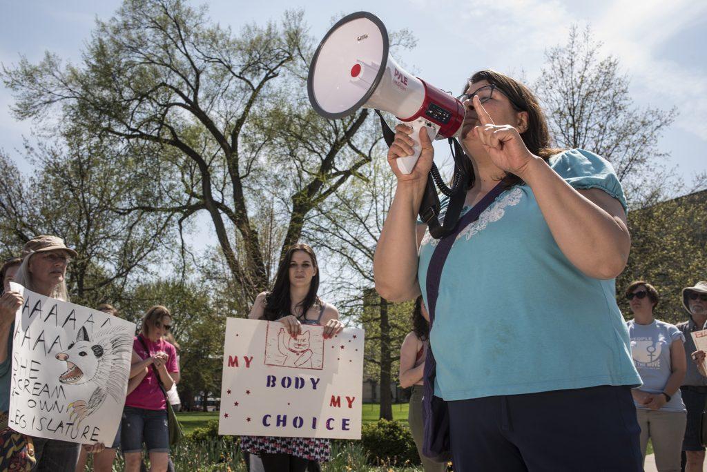 A woman speaks during a protest on the Pentacrest in Iowa City on Saturday, May 5. The protest was held in response to Gov. Kim Reynoldss signing of a new bill that will ban abortions after a heartbeat is detected in the early stages of pregnancy. (Ben Allan Smith/The Daily Iowan)