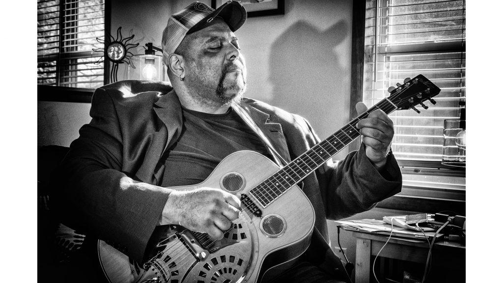 Blues musician Kevin Burt poses for a portrait in his Coralville home on Wednesday, Feb. 7, 2018. Burt recently won awards in the acoustic category at the International Blues Festival in Memphis. (Nick Rohlman/The Daily Iowan)