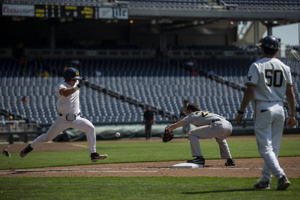 Iowa's Chris Whelan recieves a throw at first during Iowa's Big Ten tournament Game against Michigan at TD Ameritrade Park in Omaha, Neb. on Wed. May 23, 2018. The Wolverines defeated the Hawkeyes 2-1 in extra innings. 