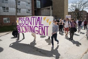 Protesters march from the Pentacrest to the home of UI President Bruce Harreld on May 4, 2018. The UIs nontenured faculty — grown to 52 percent since 2011 — advocated for greater job security, fair pay, and benefits. (Olivia Sun/The Daily Iowan)