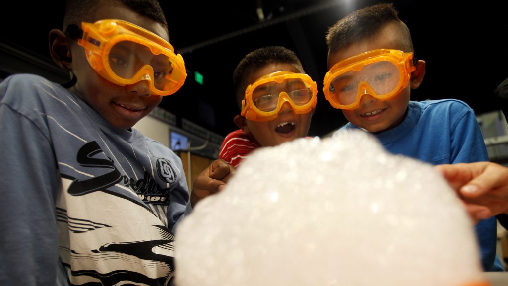 Students in an October 2011 file image react during a science experiment in first grade class at Alexander Science Center School in Los Angeles, learning about three states of matter: gas, liquid, and solid. New education guidelines in Iowa will make science education more analytical rather than focusing on memorization. (Francine Orr/Los Angeles Times/TNS)