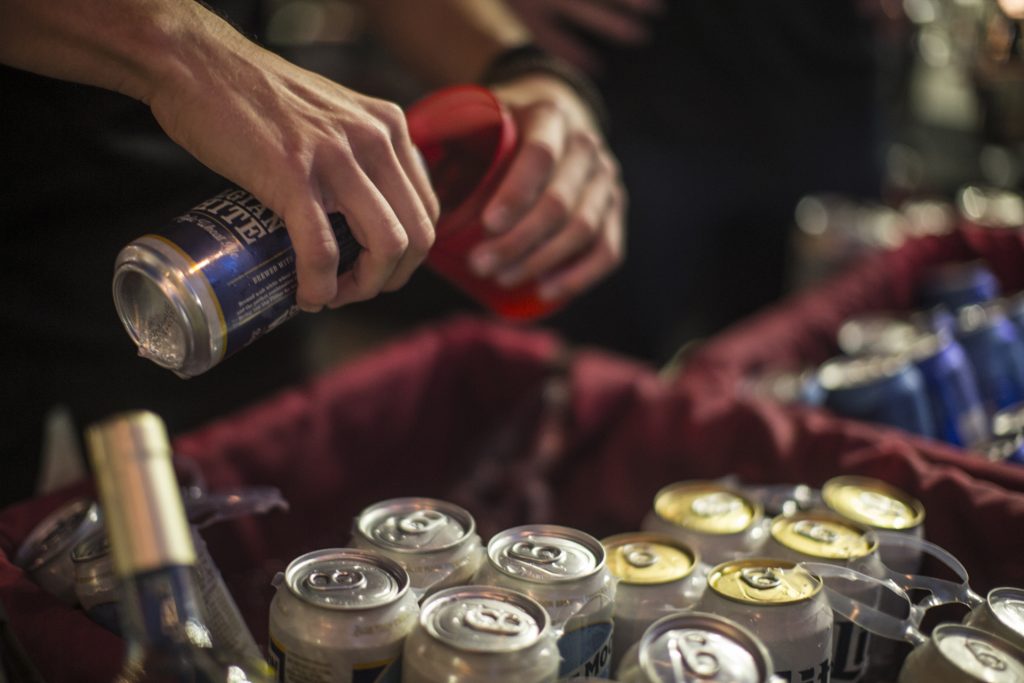 A bartender pours a beer into an approved drinking vessel during the Iowa City Downtown District Block Party on Saturday June 23, 2018. The 2nd annual event during which open containers were allowed in a select portion of downtown attracted thousands of guests and featured a variety of activities and performances. (Nick Rohlman/The Daily Iowan)